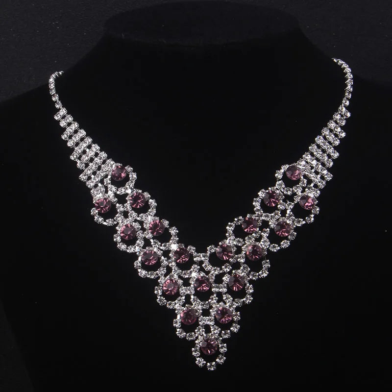 High end and elegant bridal accessories, including a necklace and a pair of earrings, set in blue, red, and purple. Bridal acces