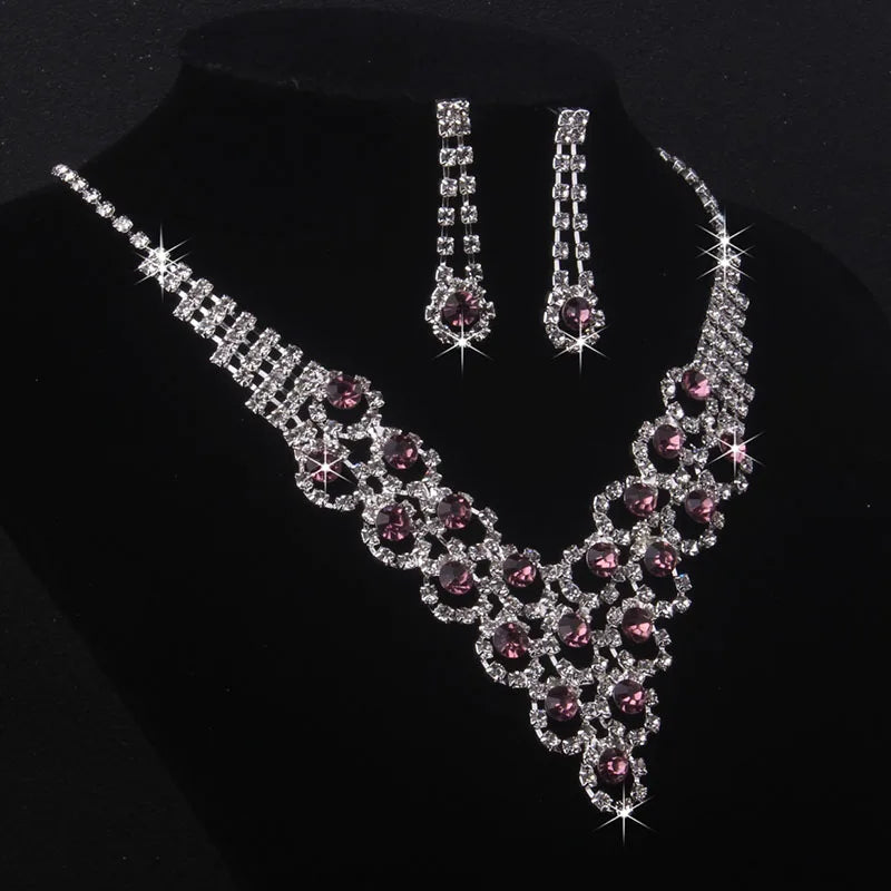High end and elegant bridal accessories, including a necklace and a pair of earrings, set in blue, red, and purple. Bridal acces