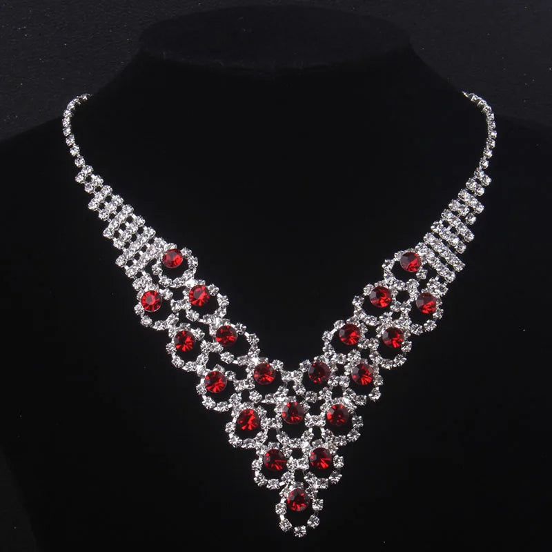 High end and elegant bridal accessories, including a necklace and a pair of earrings, set in blue, red, and purple. Bridal acces