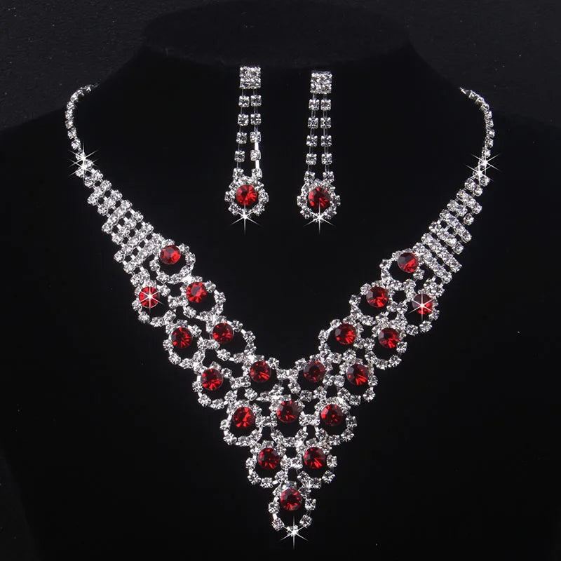 High end and elegant bridal accessories, including a necklace and a pair of earrings, set in blue, red, and purple. Bridal acces