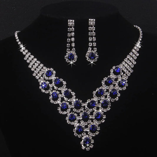 High end and elegant bridal accessories, including a necklace and a pair of earrings, set in blue, red, and purple. Bridal acces
