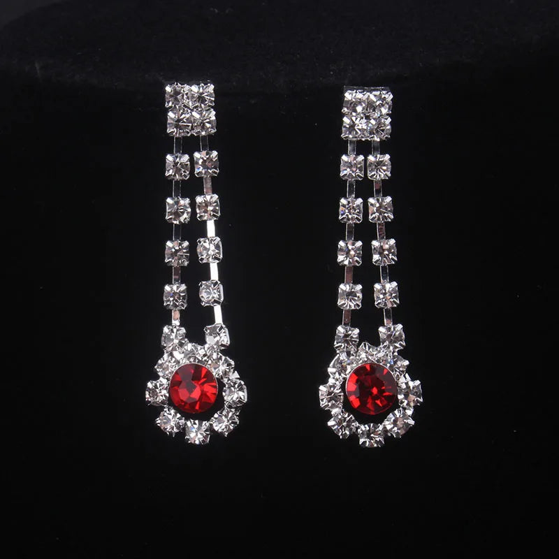 High end and elegant bridal accessories, including a necklace and a pair of earrings, set in blue, red, and purple. Bridal acces